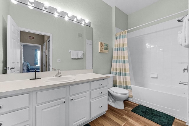 7671 Comrow St Unit 202, Kissimmee, FL 34747 - bathroom with toilet, shower / tub combo, wood finished floors, vanity, and ensuite bath