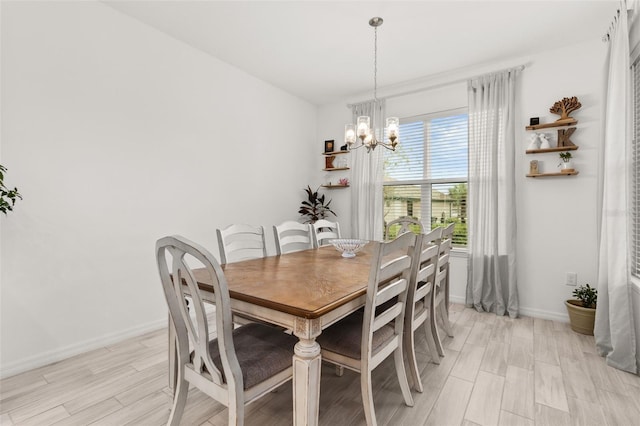 dining room with a notable chandelier and light wood-type flooring