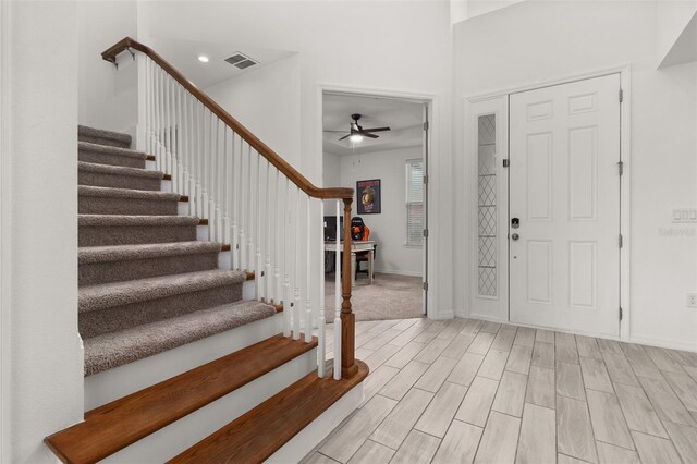 foyer entrance featuring ceiling fan and light wood-type flooring