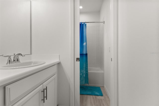 bathroom featuring vanity, shower / bath combination with curtain, and hardwood / wood-style flooring