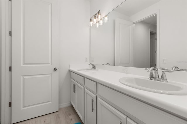 bathroom with vanity and wood-type flooring