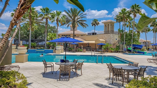 view of pool featuring a patio and a water slide