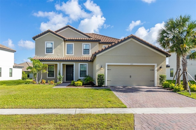 mediterranean / spanish house featuring a front yard and a garage