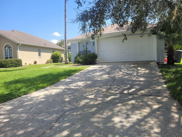 ranch-style home with a garage and a front lawn