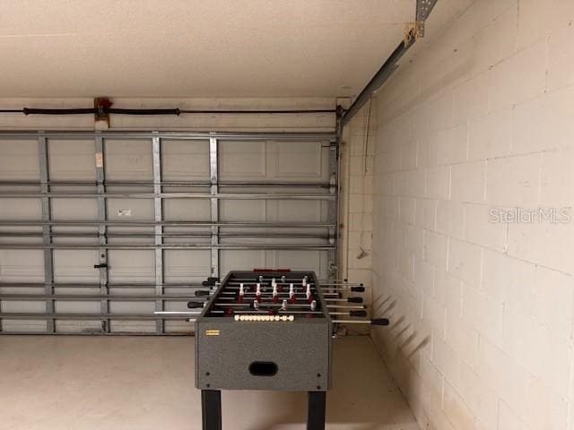 recreation room featuring concrete flooring