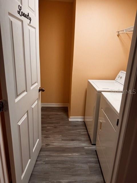 laundry area with washer and clothes dryer and dark hardwood / wood-style flooring