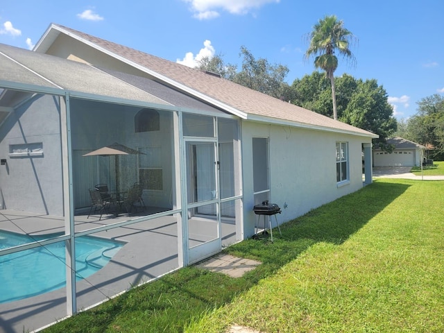 rear view of house featuring a lawn and a patio area