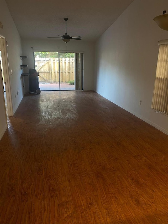 unfurnished living room with hardwood / wood-style floors, ceiling fan, and lofted ceiling