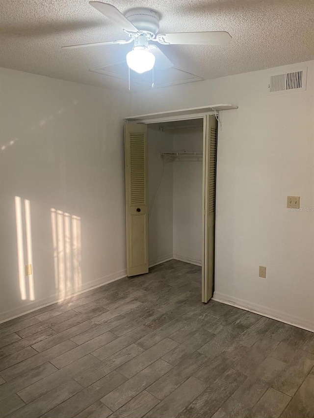 unfurnished room featuring ceiling fan, a textured ceiling, and hardwood / wood-style floors