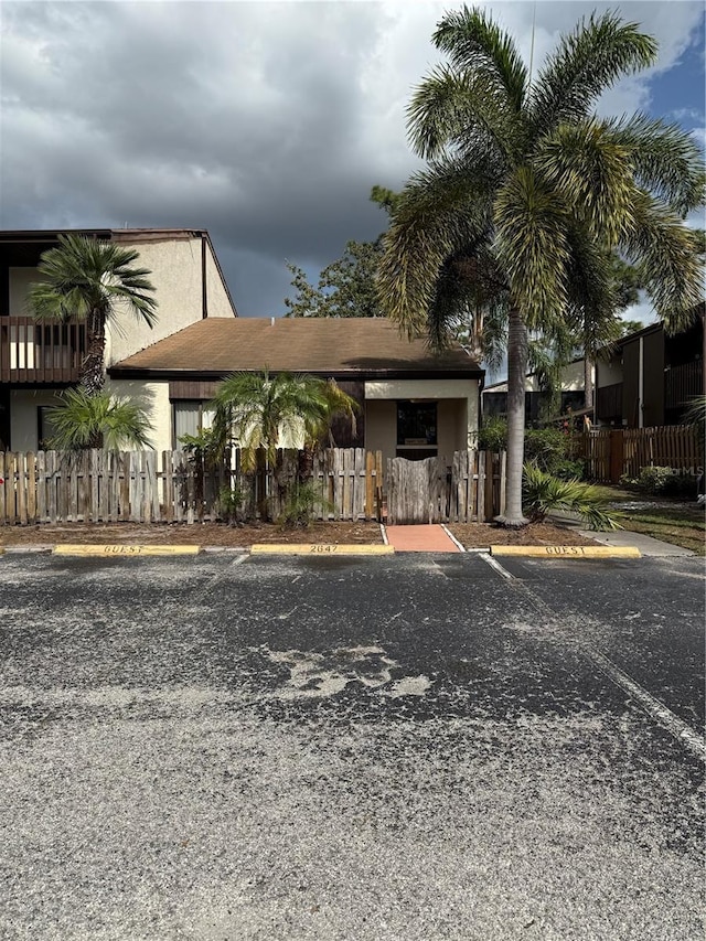 2647 Surrey Ct Unit 2647, Kissimmee, FL 34741 - view of front of property with a fenced front yard, stucco siding, and uncovered parking
