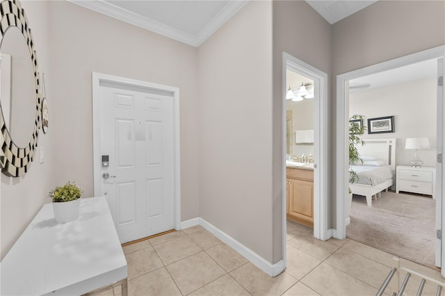 entrance foyer with ornamental molding, light colored carpet, and sink