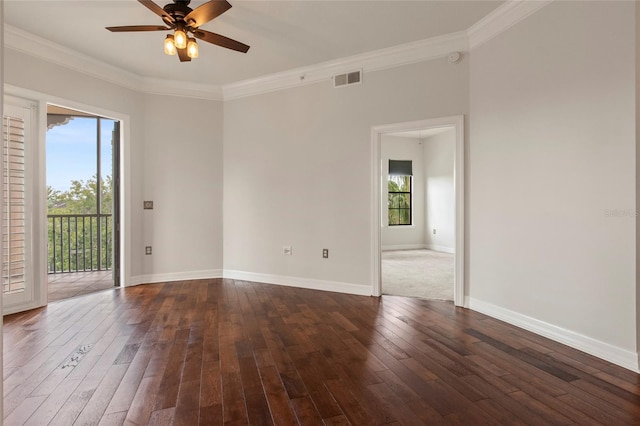 spare room featuring dark wood-type flooring, visible vents, a wealth of natural light, and ceiling fan