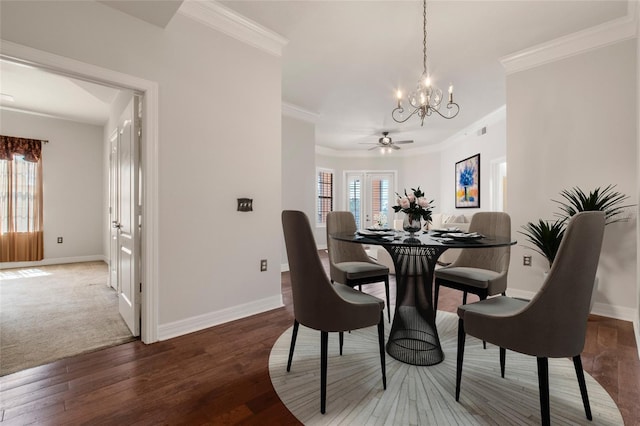 dining room featuring baseboards, a chandelier, crown molding, and hardwood / wood-style flooring