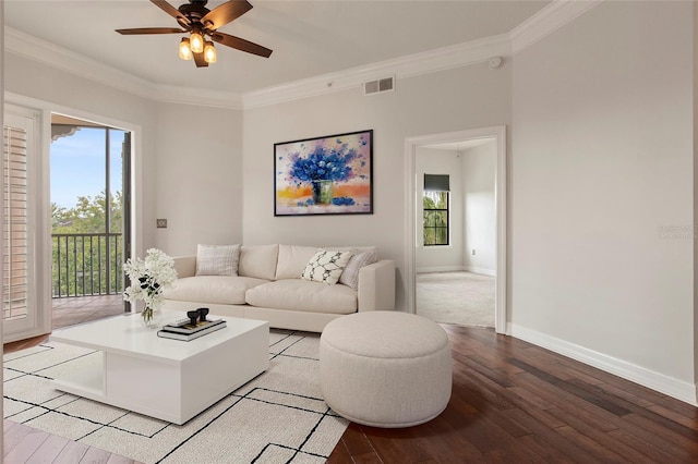 living room featuring crown molding, plenty of natural light, and visible vents