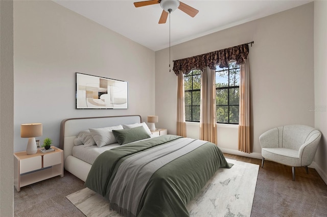 bedroom with a ceiling fan, carpet, and baseboards