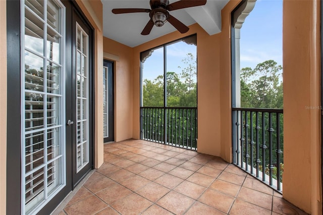 unfurnished sunroom featuring ceiling fan