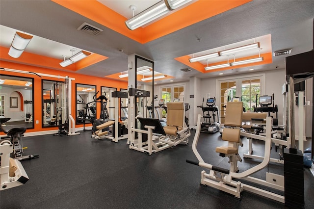 exercise room with visible vents, baseboards, and french doors