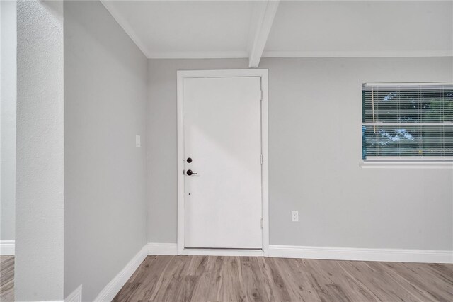 entrance foyer with light hardwood / wood-style flooring and beam ceiling