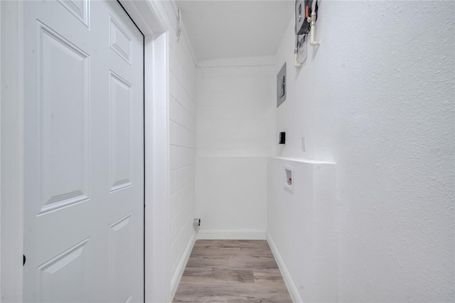 washroom featuring washer hookup, laundry area, baseboards, and wood finished floors