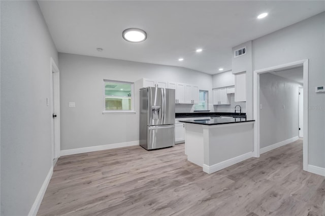 kitchen with stainless steel fridge with ice dispenser, kitchen peninsula, sink, light wood-type flooring, and white cabinets