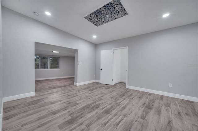 spare room with recessed lighting, wood finished floors, and baseboards