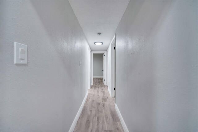 hallway with light wood-type flooring