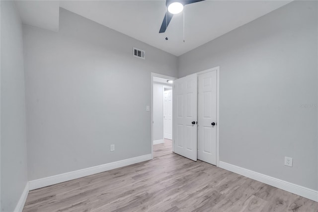 unfurnished bedroom with ceiling fan and light wood-type flooring