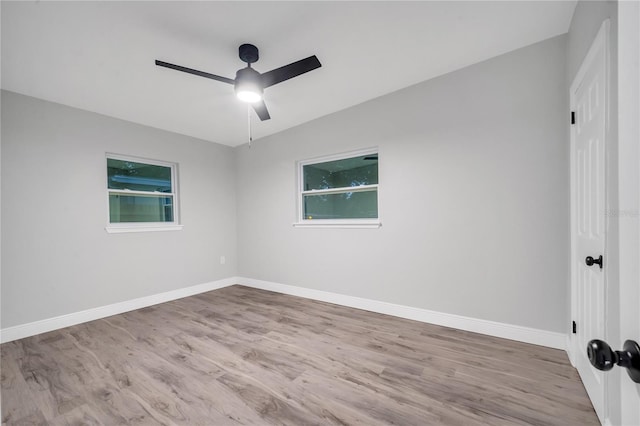 spare room with ceiling fan, baseboards, and wood finished floors