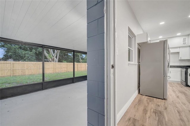 interior space with light wood-type flooring, recessed lighting, and baseboards