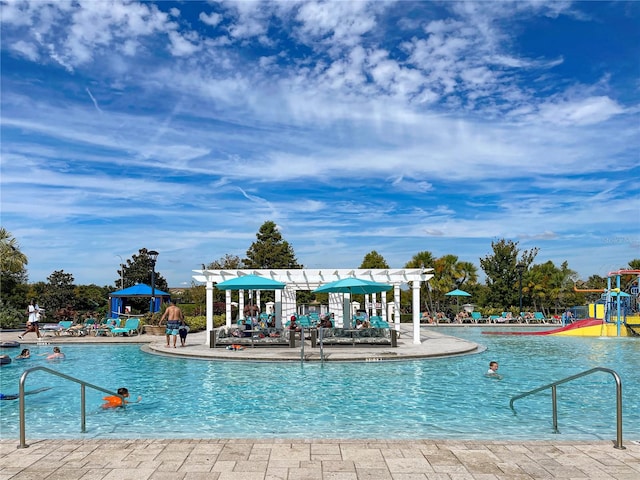 view of pool with a gazebo and a playground