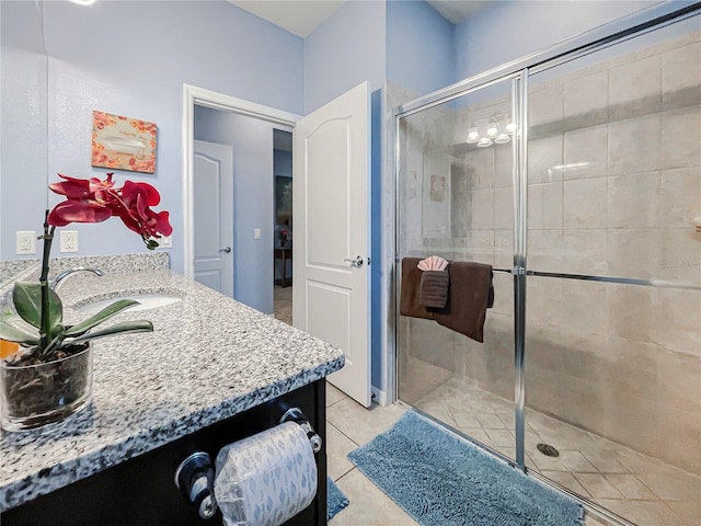 bathroom featuring vanity, walk in shower, and tile patterned flooring