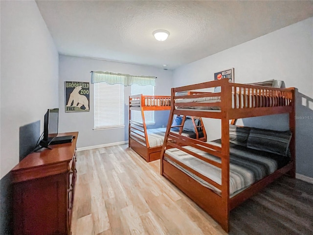 bedroom with wood-type flooring and a textured ceiling