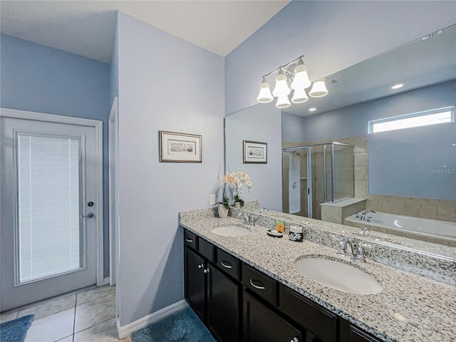 bathroom featuring vanity, shower with separate bathtub, and tile patterned floors