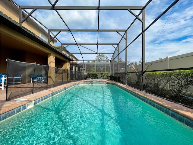 view of pool with a patio area and a lanai