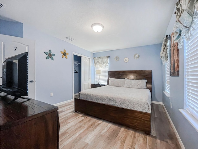 bedroom featuring light hardwood / wood-style flooring and a closet