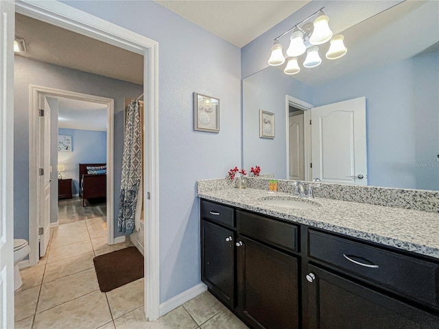 bathroom featuring vanity, toilet, and tile patterned flooring