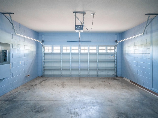 garage featuring a garage door opener and electric panel