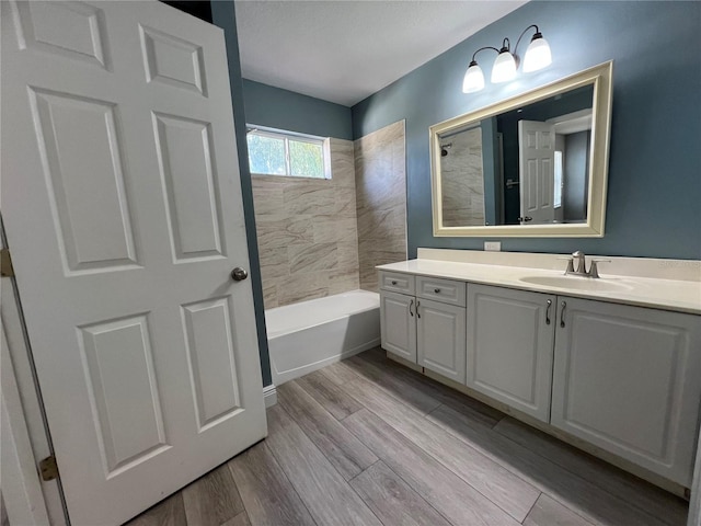 full bathroom featuring shower / bathing tub combination, wood finished floors, and vanity