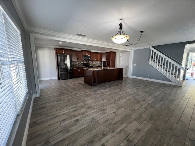 kitchen with open floor plan, crown molding, backsplash, and black appliances