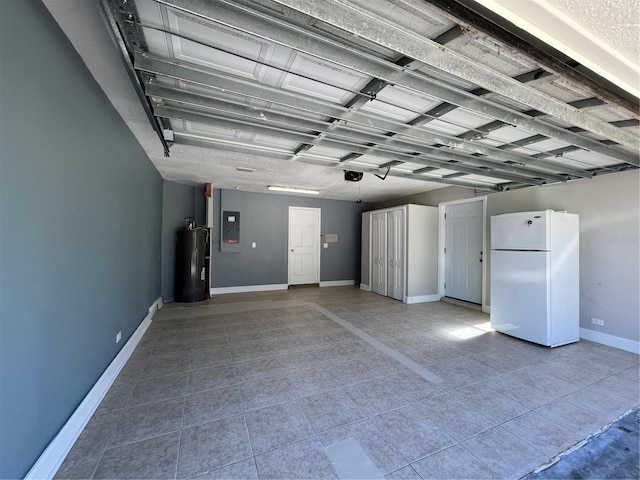 garage featuring electric panel, water heater, baseboards, and freestanding refrigerator