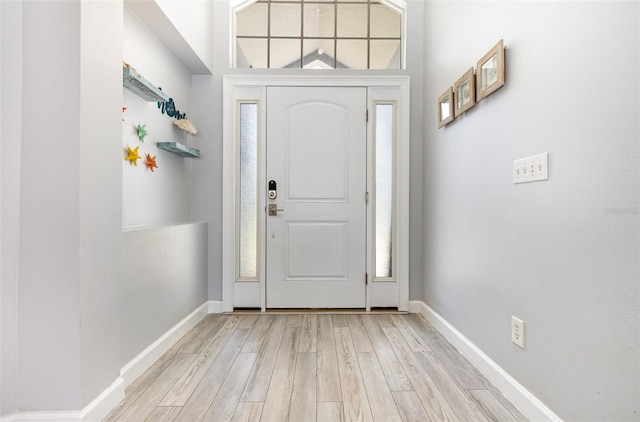 entrance foyer with light hardwood / wood-style flooring and a wealth of natural light