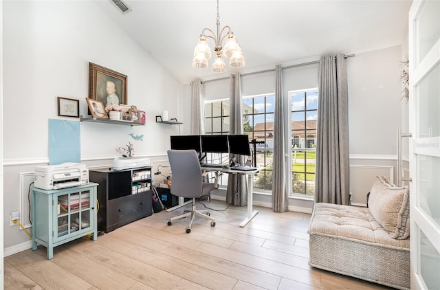 office with vaulted ceiling, a notable chandelier, and light hardwood / wood-style floors