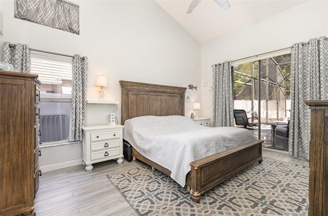 bedroom with light hardwood / wood-style flooring, ceiling fan, high vaulted ceiling, and access to exterior