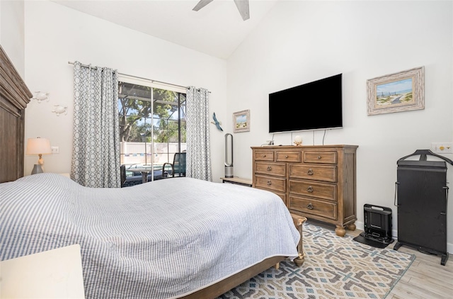 bedroom with high vaulted ceiling, access to exterior, ceiling fan, and light hardwood / wood-style floors