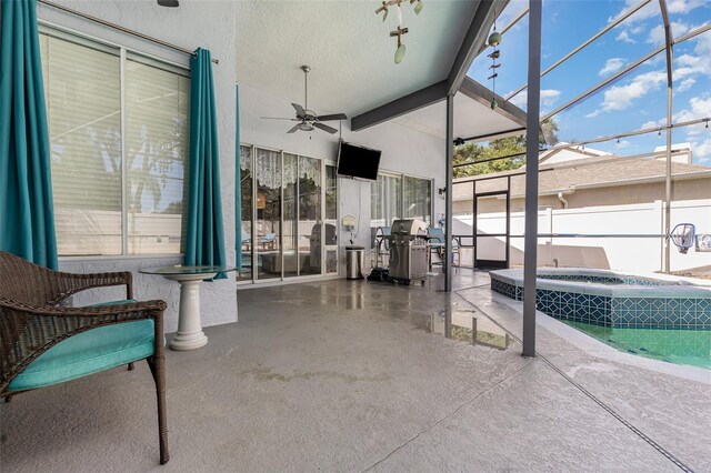 view of patio / terrace with a lanai, area for grilling, an in ground hot tub, and ceiling fan