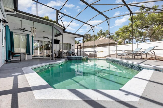 view of pool featuring an in ground hot tub, ceiling fan, a patio, and a lanai