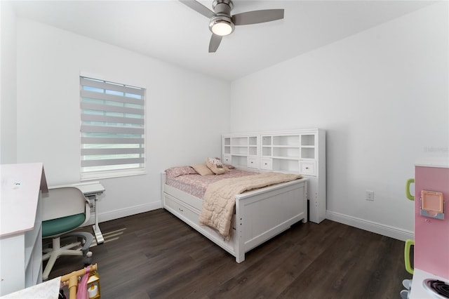 bedroom with dark hardwood / wood-style flooring and ceiling fan