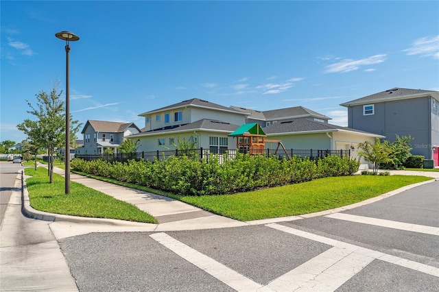 view of front of property with a playground and a front yard