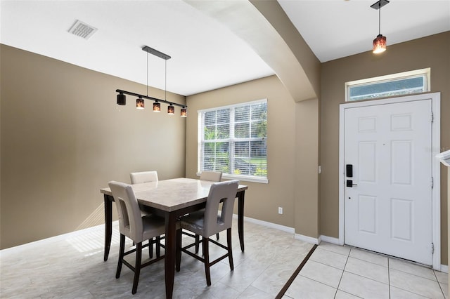 dining space featuring light tile patterned flooring