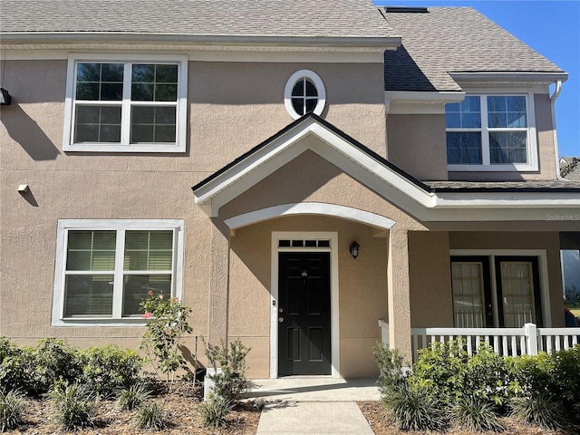 view of exterior entry featuring a porch